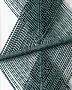 close up detail of woven green thread in geometric forms