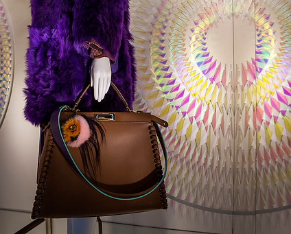 chris wood commission for shop window front for fendi, featuring a mannequ in fur coat and leather bag and chris wood's dichrois wall glass installation, consulted by advisory service artelier