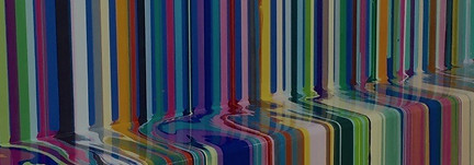 various dark hued colours (red, green, blue, purple) streaming down a wall jutting at a right angle on a mid-point on wall.