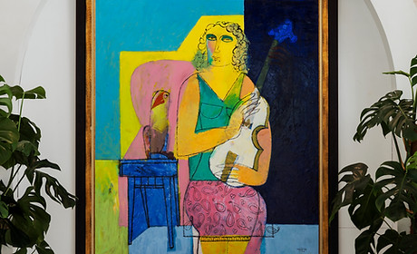 Yellow lady portrait in raffles bahrain reception room credit to Tooze Studio