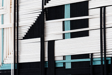 close up of matthias de vogel's woven artwork featuring geometric layering of blues, blacks and whitesjpg