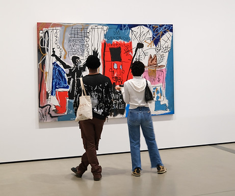 two art lovers visiting a contemporary art exhibition feature a basquiat
