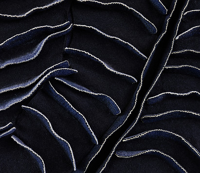 close up texture shot of kristy kún in navys and golds in a wave like, leaf style aesthetic