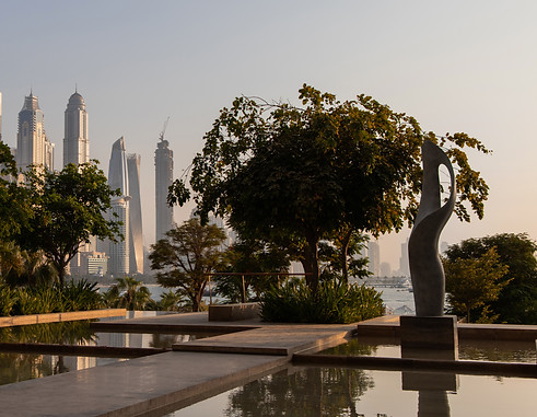henry moore inspired contemporary abstract sculpture in the water garden of one at palm jumeirah dubai at sunset, a series of luxury branded residences where the art collection was curated by artelier art consultancy