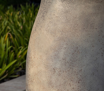 detail of curved rock sculpture in specks of greys and blacks by artelier