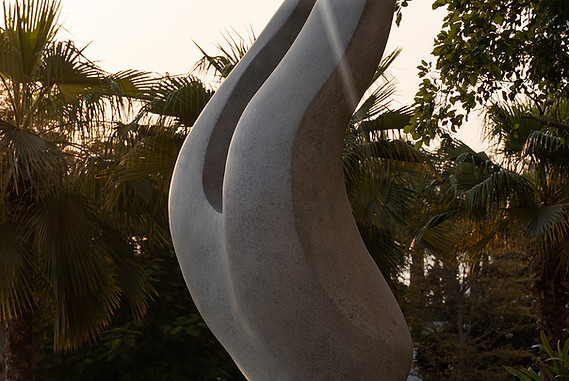 close up of henry moore inspired contemporary abstract sculpture in the water garden of one at palm jumeirah dubai at sunset, a series of luxury branded residences where the art collection was curated by artelier art consultancy