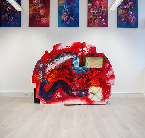feature wall artwork commissioned by artelier in situ of the artist studio outside of the aircraft the project was organised for, featuring a semi circular artpiece displaying a myriad of reds, whites, blues and whites combining acrylic and oil