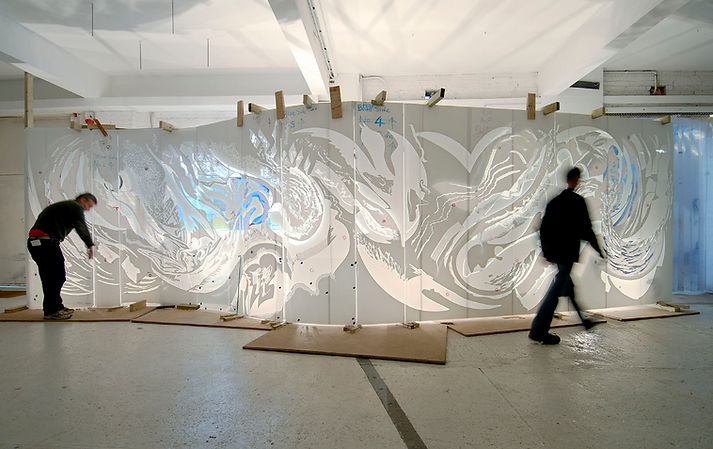 danny lane's exhibition being prepared by two logisticians in a blurred movement