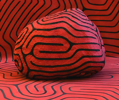 rocks in my bed exhibition by peter randall page the artist featuring a large rock with wave like patterns painted on top of them