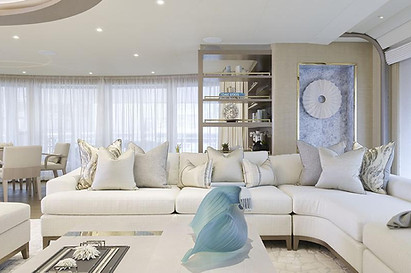 example of technical yacht expertise and durability by artelier's private art curators for a private superyacht featuring a sitting room in whites and blues with abstract wooden carven sculptures