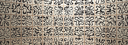 black drawing on a white panelled feature wall. black drawings show abstract lines.