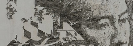 chiselled mural showing a man with geometric triangular forms dispersed against the figure on the white wall.