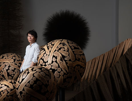 portrait of © Jaehyo Lee in his studio, around his wooden hand curved spherical sculptures