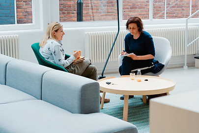 2 women consulting in an open lobby business space