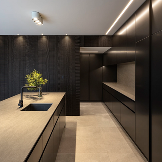 A sophisticated dark-toned wood feature wall commissioned for a living room. This wood art design encompasses bas-relief.