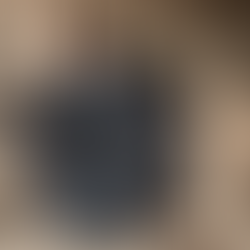 The artist standing in front of his carved wood sculpture commissioned by Artelier art consultancy