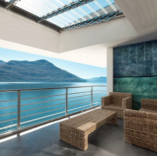 A blue eglomise hand painted mirror art with a vertical axis that mirrors the blue shades of the ocean.