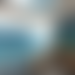 A blue eglomise hand painted mirror art with a vertical axis that mirrors the blue shades of the ocean.