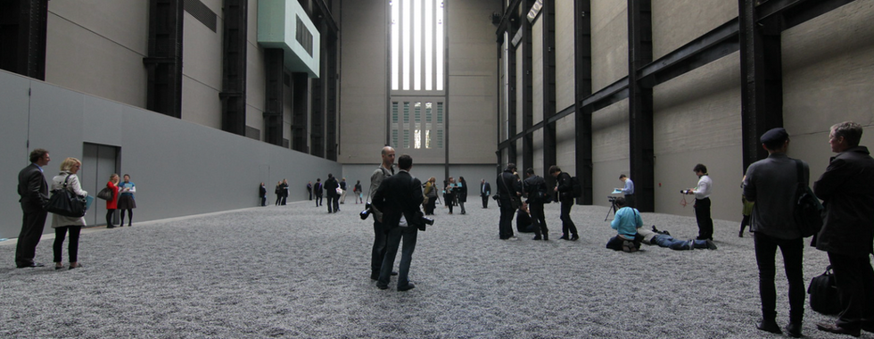© Credit to photography Didier Leroi, visitors in the tate modern walking on a vast grey space of sunflower seeds