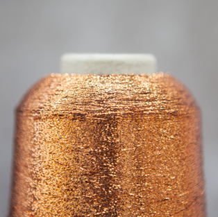 close up of orangey gold metallic thread