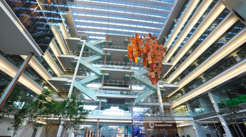 corporate art collection in the industrial building's lobby hanging from the ceiling in an abstract interpretation colourful of the continent africa