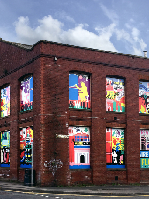 A continuation of previous vibrant murals in pink, white, black by experienced public artist Ian Kirkpatrick on the exterior of a building, painted where windows would otherwise presumably be.