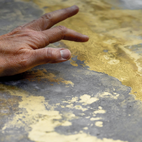 artist tracing their watercolour gold leaf artwork with their hand