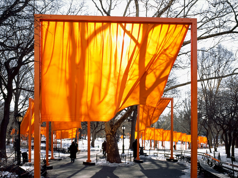 Close-up of the orange vinyl gate by Christo and Jeanne Claude blowing in the wind, set against a wintery central park in NYC.