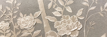white ceramic artwork with flower motifs in light bas relief