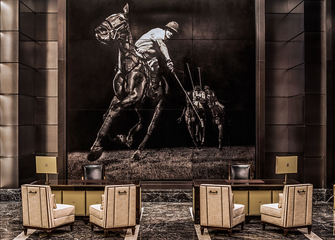 Mark evans large scale feature wall on display in a hotel reception lobby of a horse polo player